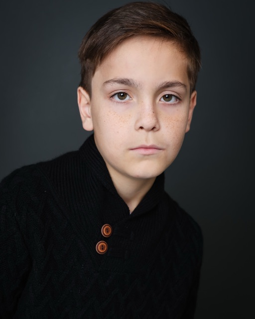 Jett Belew — theatrical, black sweater, neutral